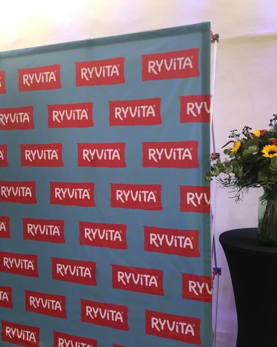 Flowers beside a branded event backdrop