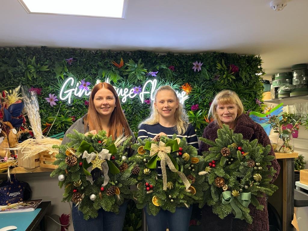 Finished Christmas wreaths made at a Gin House Flowers class