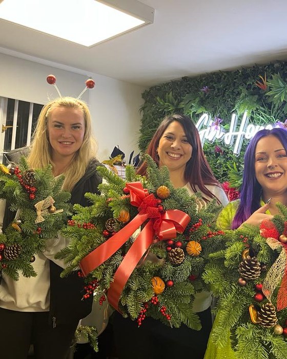 Friends with the festive wreaths they made
