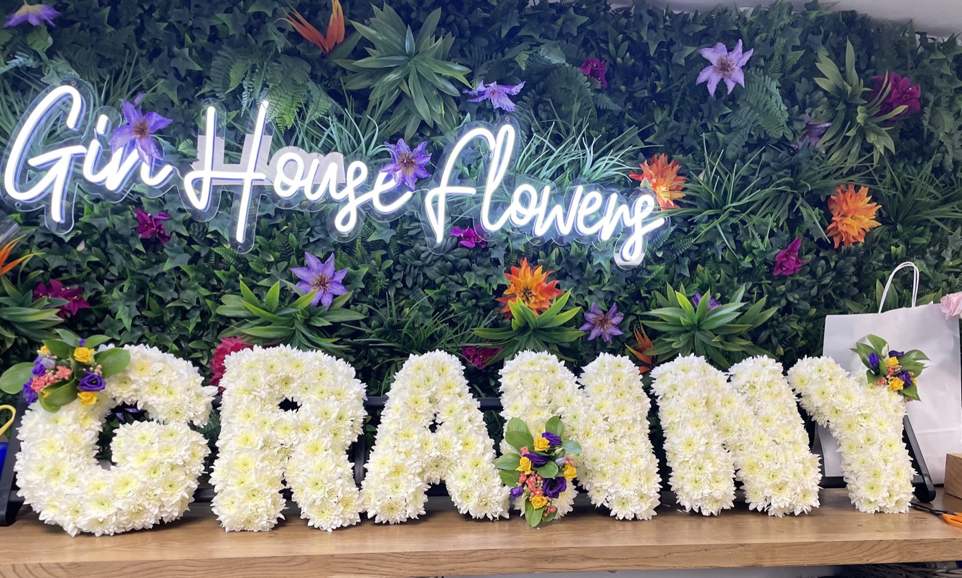 Floral lettering funeral tribute