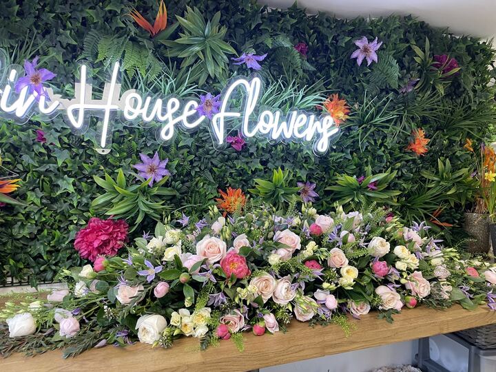 Pastel coffin spray of roses and seasonal flowers