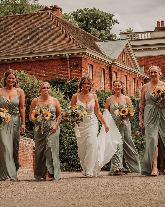 Bridal party in sage green outside a country house