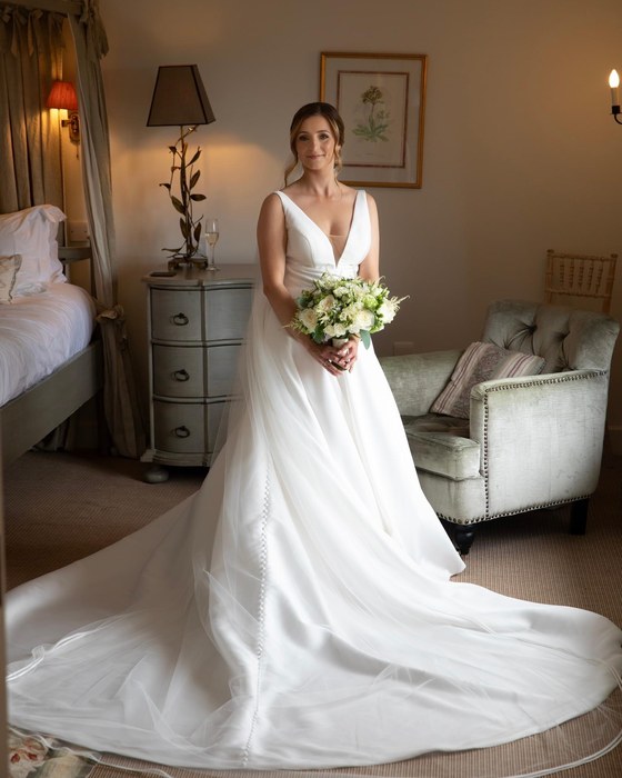 Bride holding a bouquet in an elegant room
